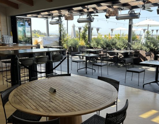 a patio with tables and chairs