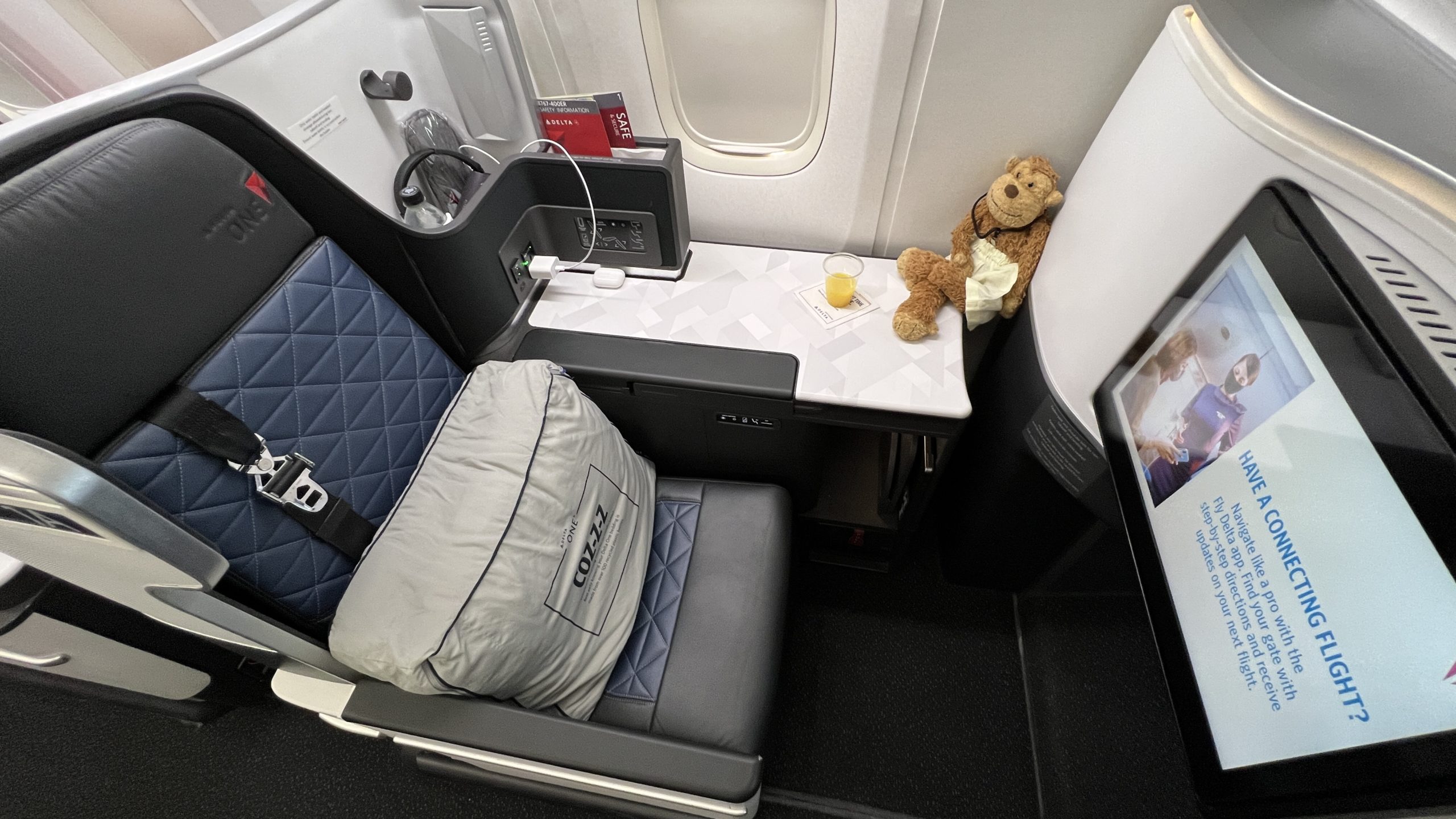 a teddy bear on a table in an airplane