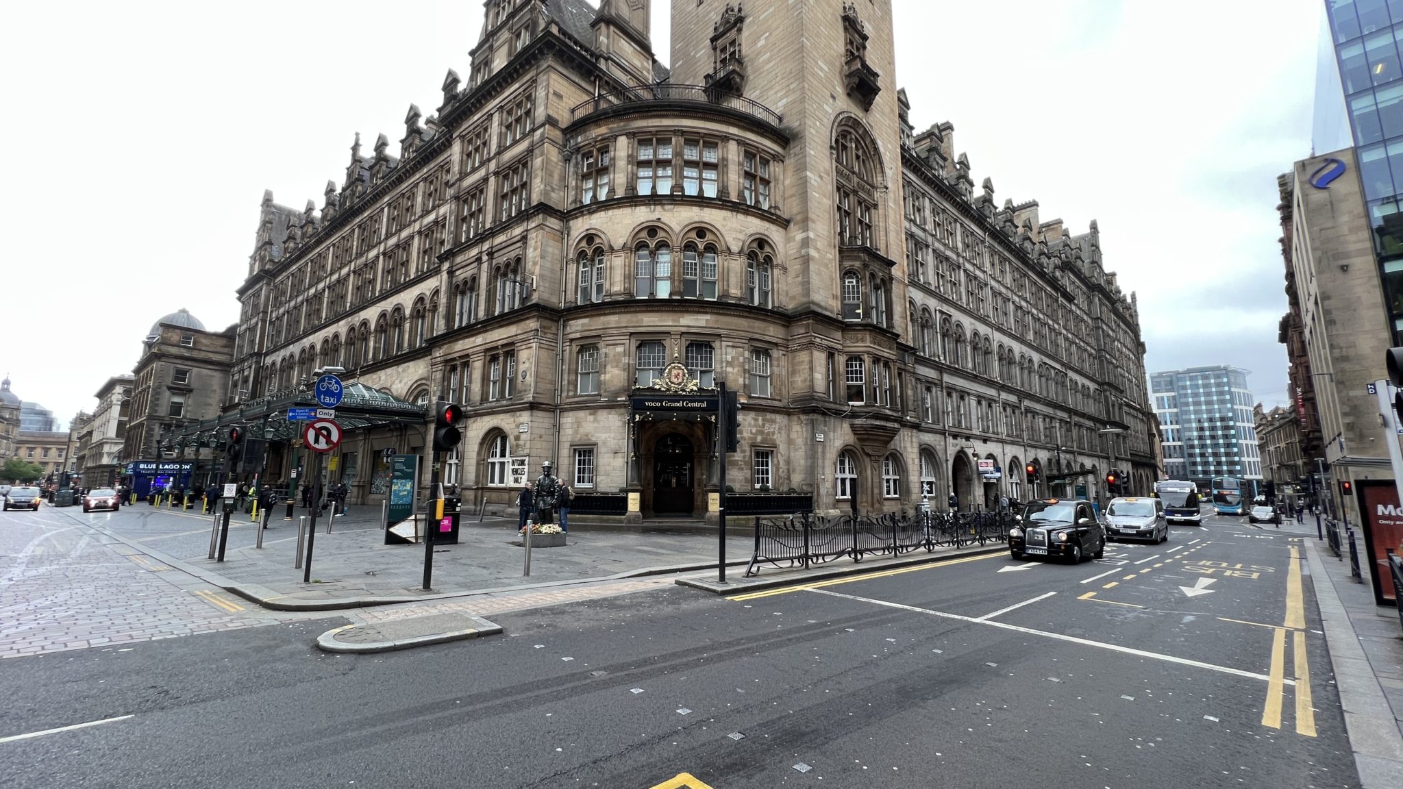 a large stone building with a large tower and a street