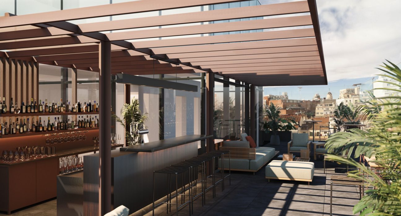 a rooftop bar with a bar and chairs