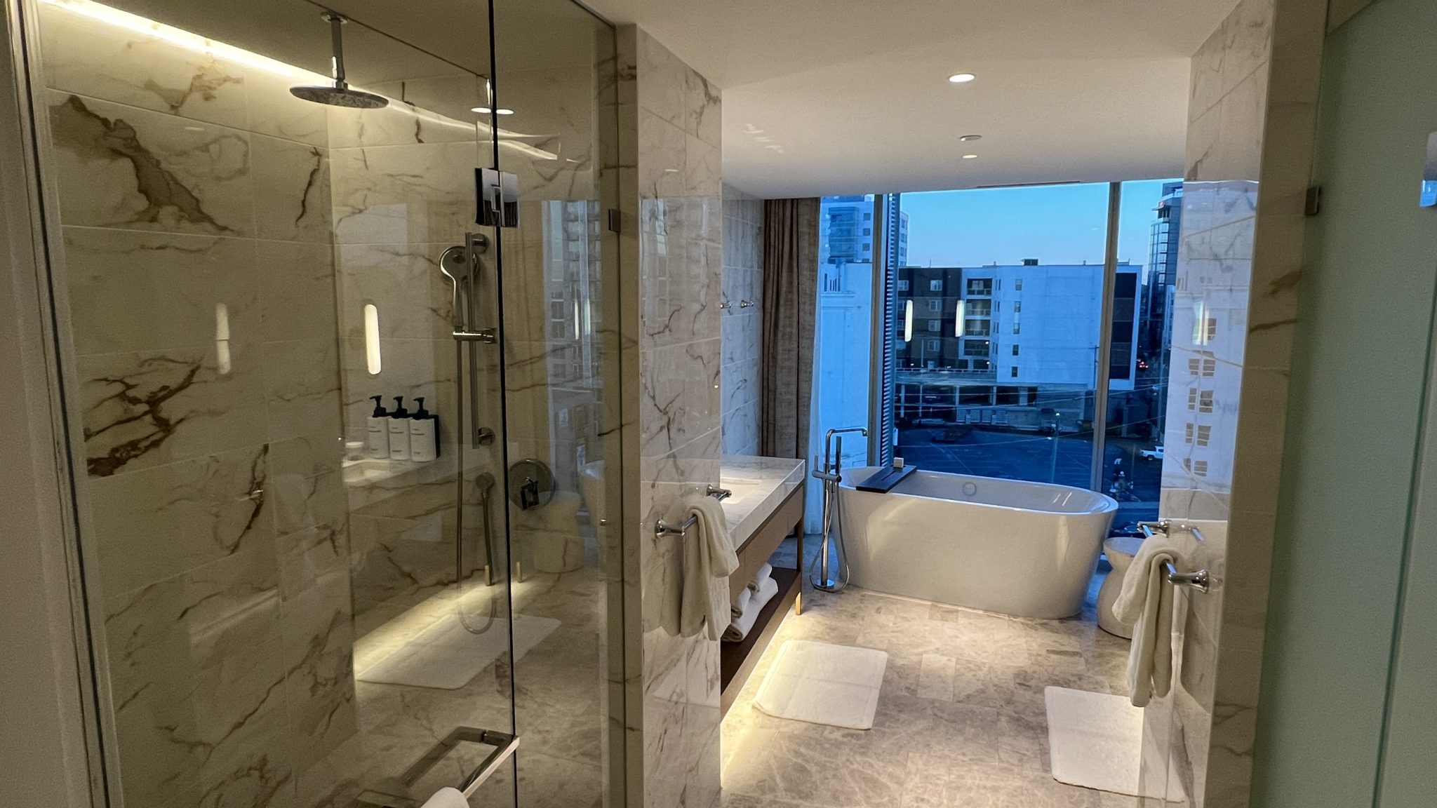 a bathroom with a glass shower and tub