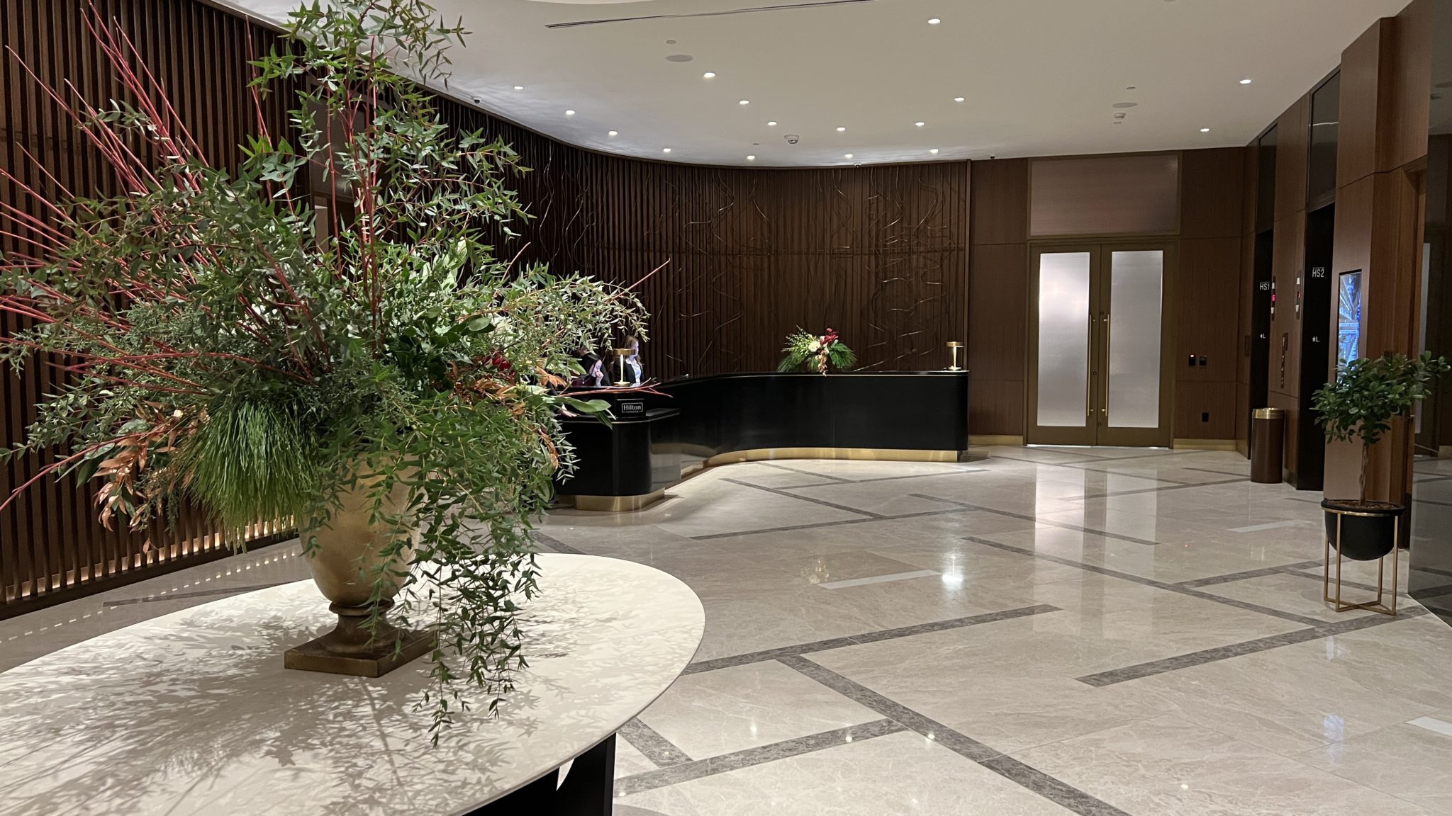 a lobby with a large plant in it