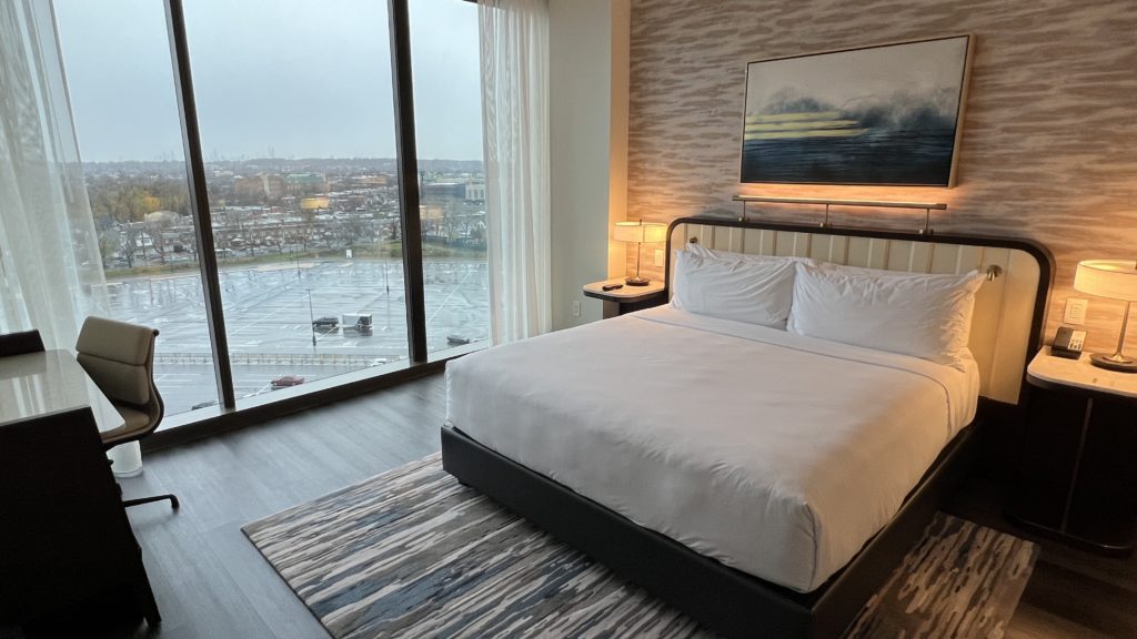a bed in a room with a view of a city