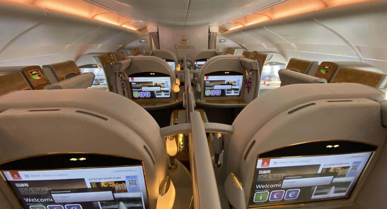 the inside of an airplane with seats and screens