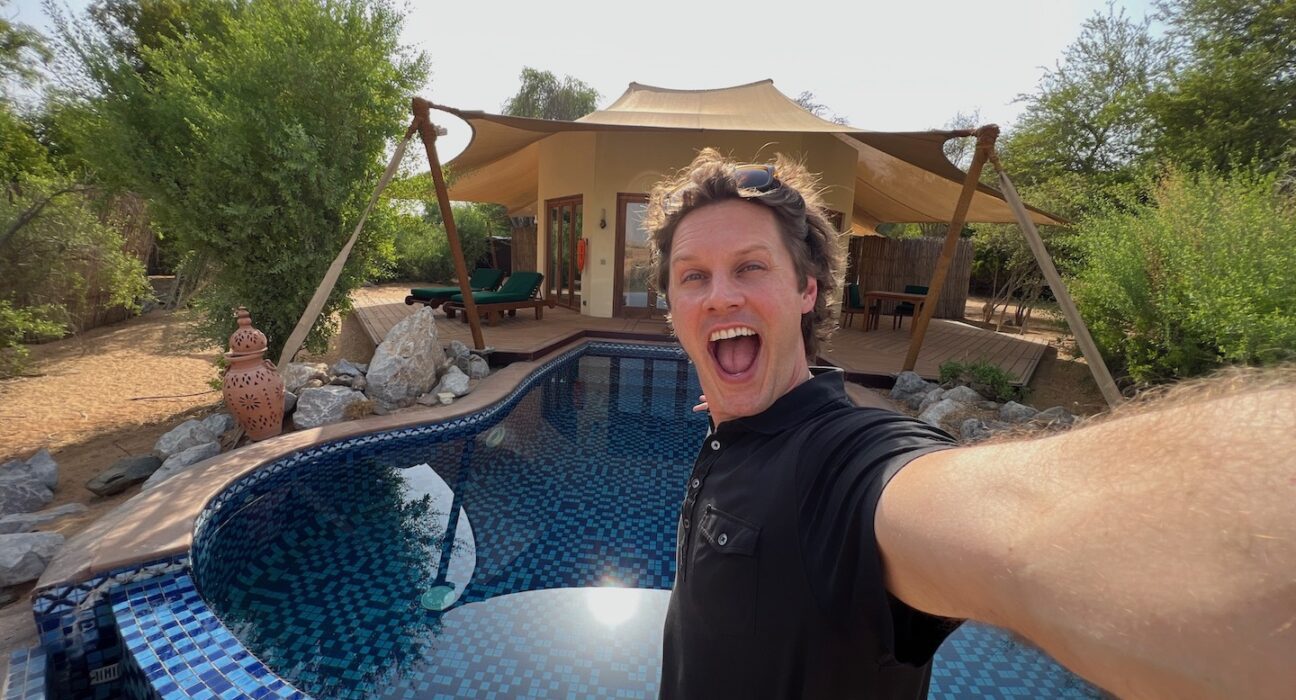 a man taking a selfie by a pool