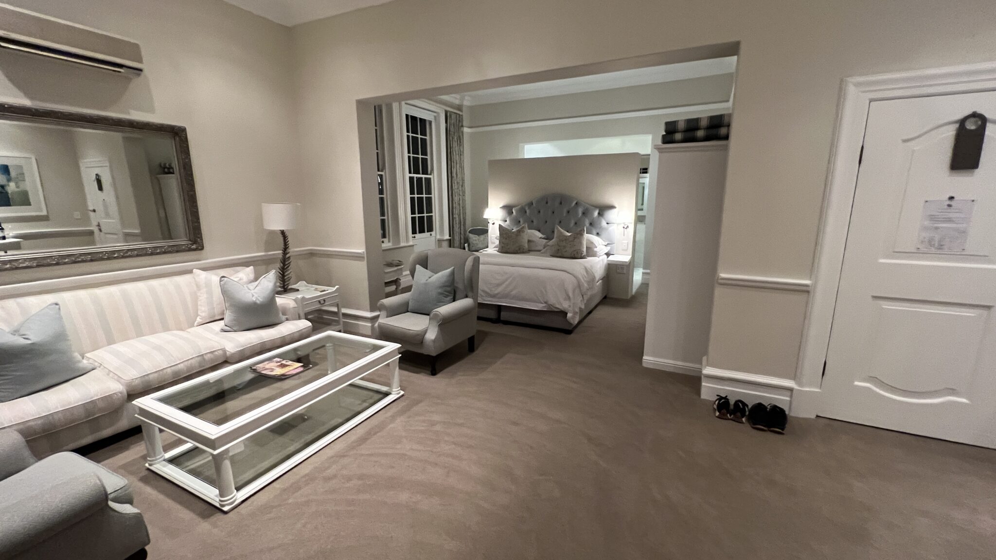 a bedroom with a glass coffee table and a bed