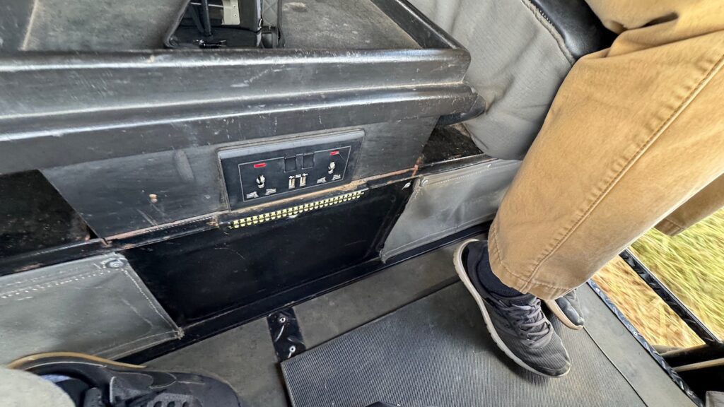 a person's feet in a black box with switches