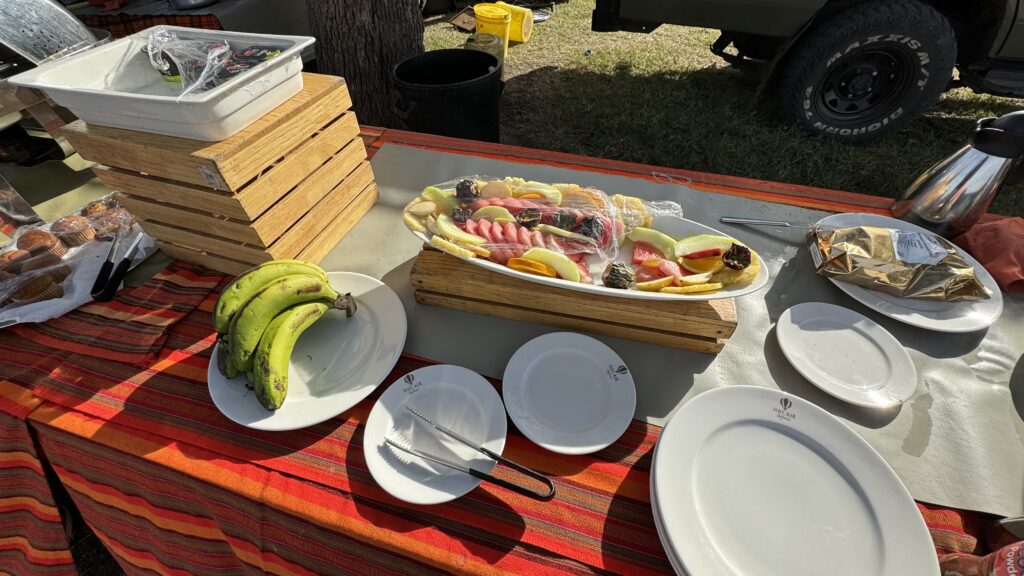 a table with plates of fruit and a plate of bananas