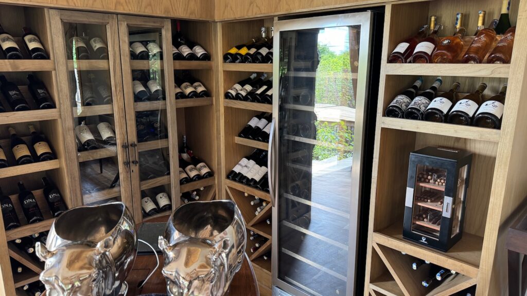 a wine cellar with a fridge and wine bottles