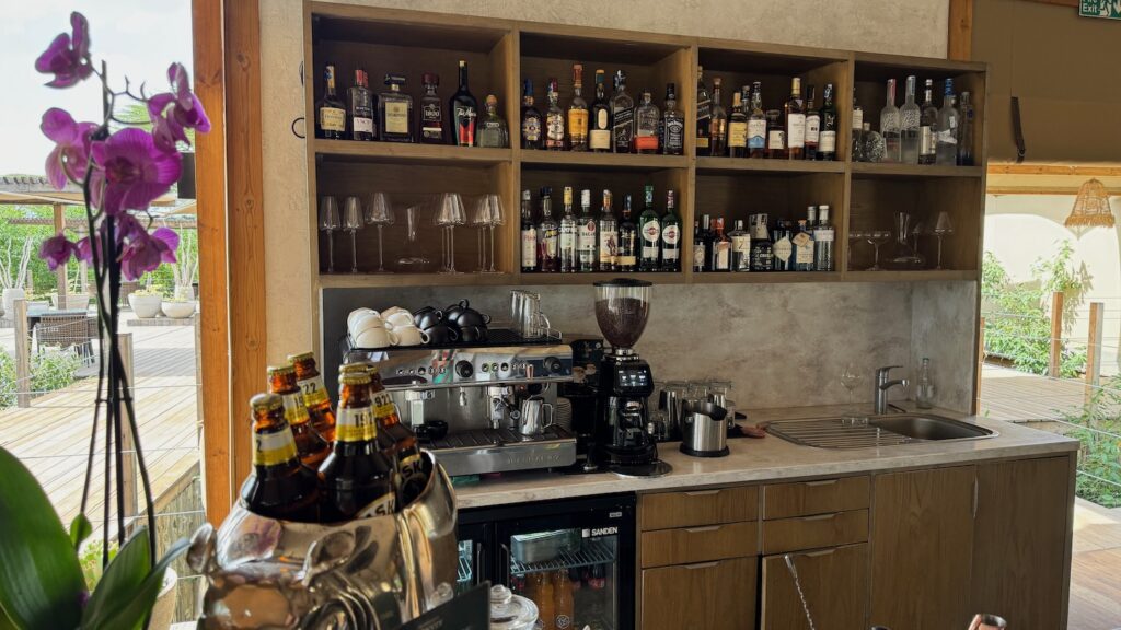 a bar with liquor bottles and coffee machine