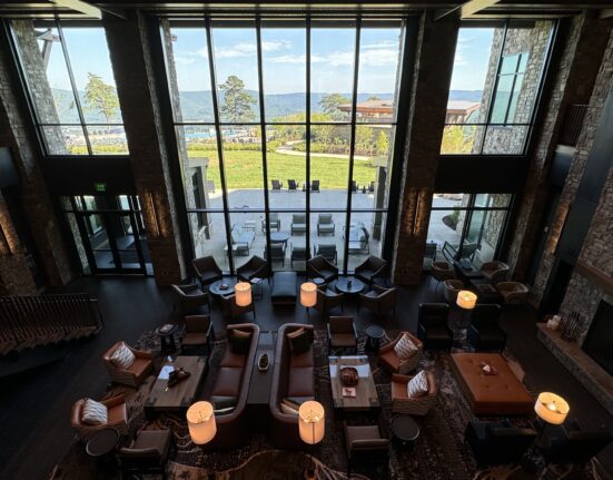 a room with a large window and a view of the water and a lake