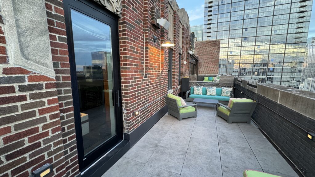 a brick building with a couch and chairs