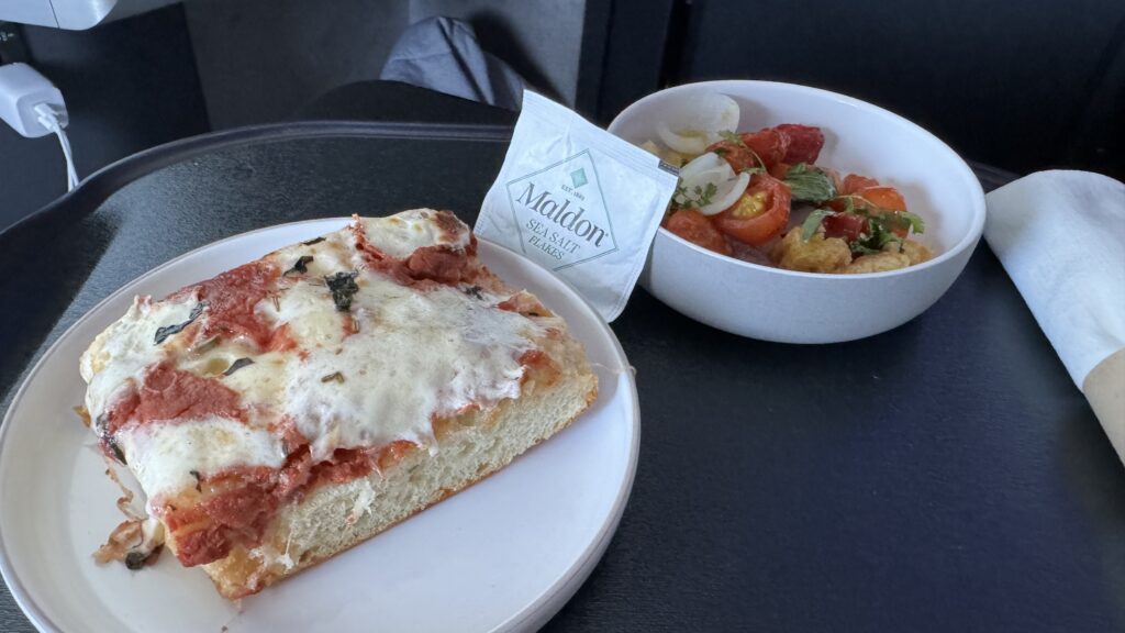 a plate of pizza and a bowl of salad