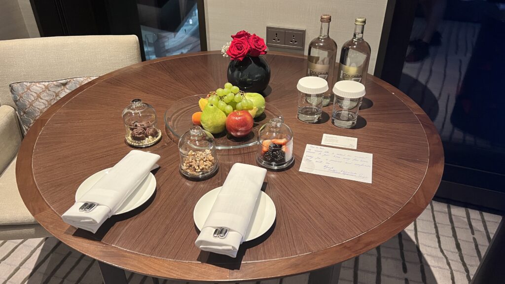 a table with fruit and glasses on it