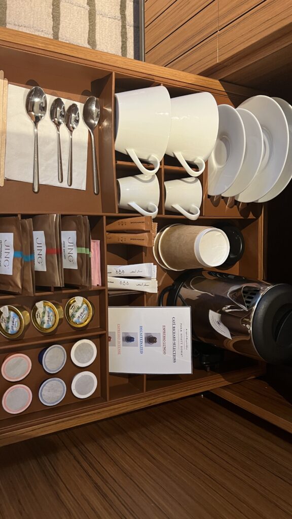 a shelf with a variety of coffee cups and saucers