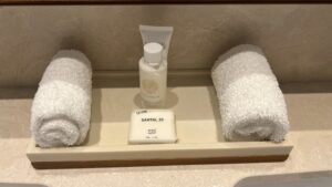 a white towel and soap on a tray