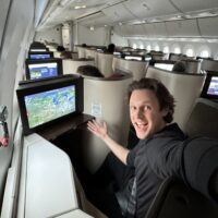 a man sitting in an airplane with a computer