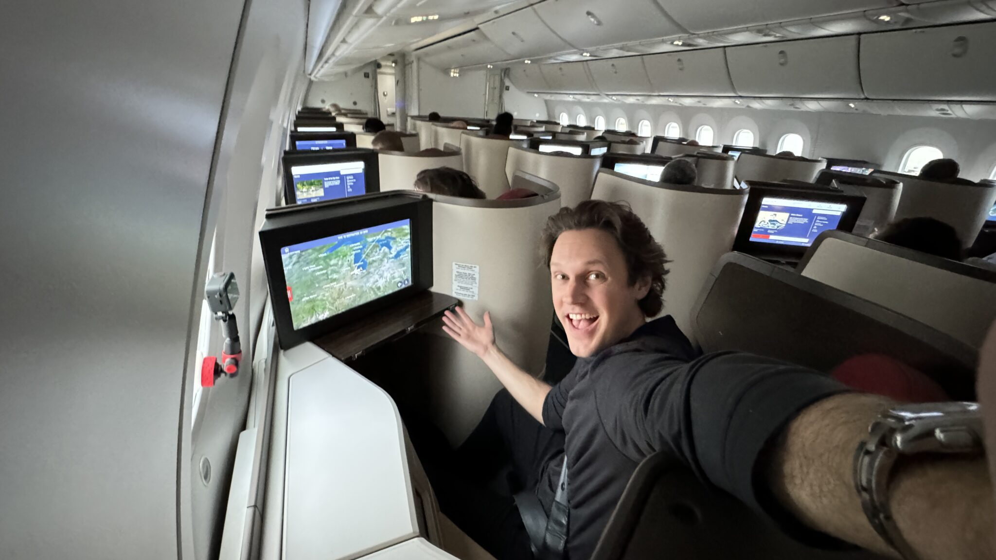 a man sitting in an airplane with a computer