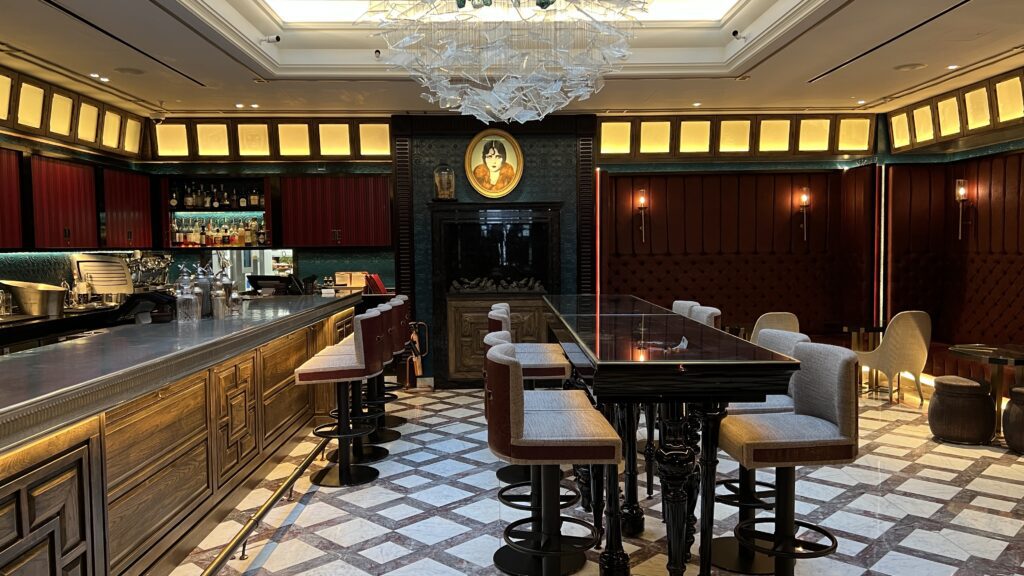 a room with a bar and a chandelier