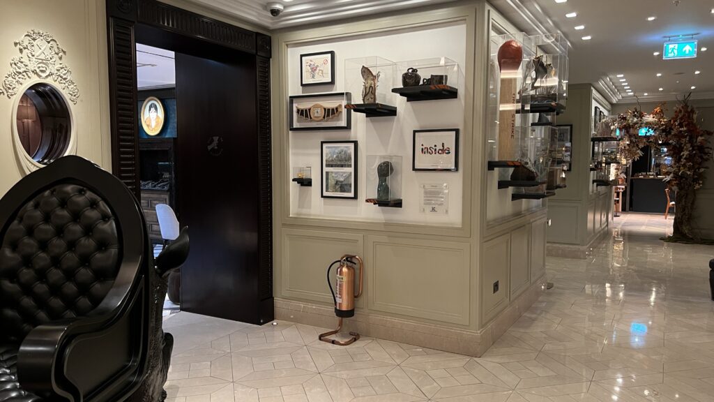 a room with a fire extinguisher and pictures on the wall