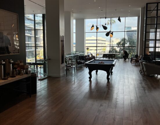 a pool table in a room with large windows