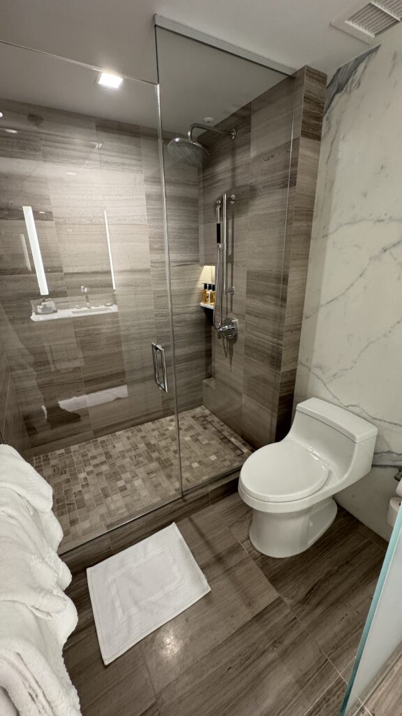 a bathroom with a glass shower and toilet