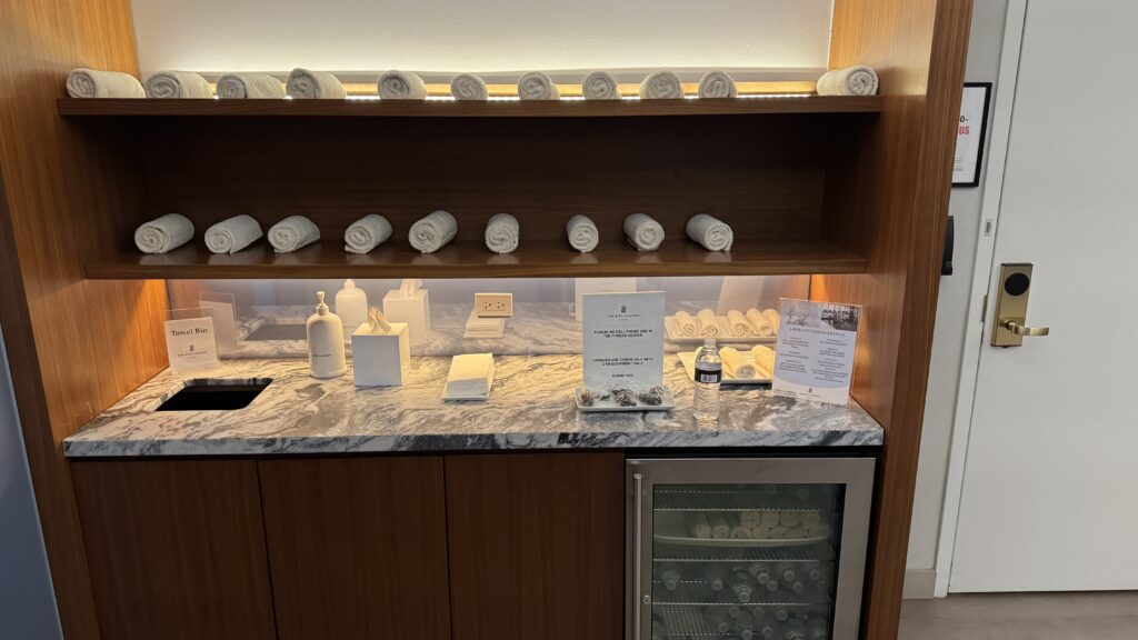 a shelf with towels and a refrigerator