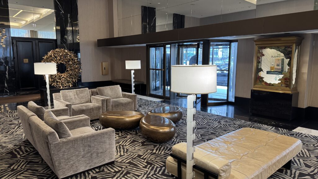 a room with a large sofa and a lamp