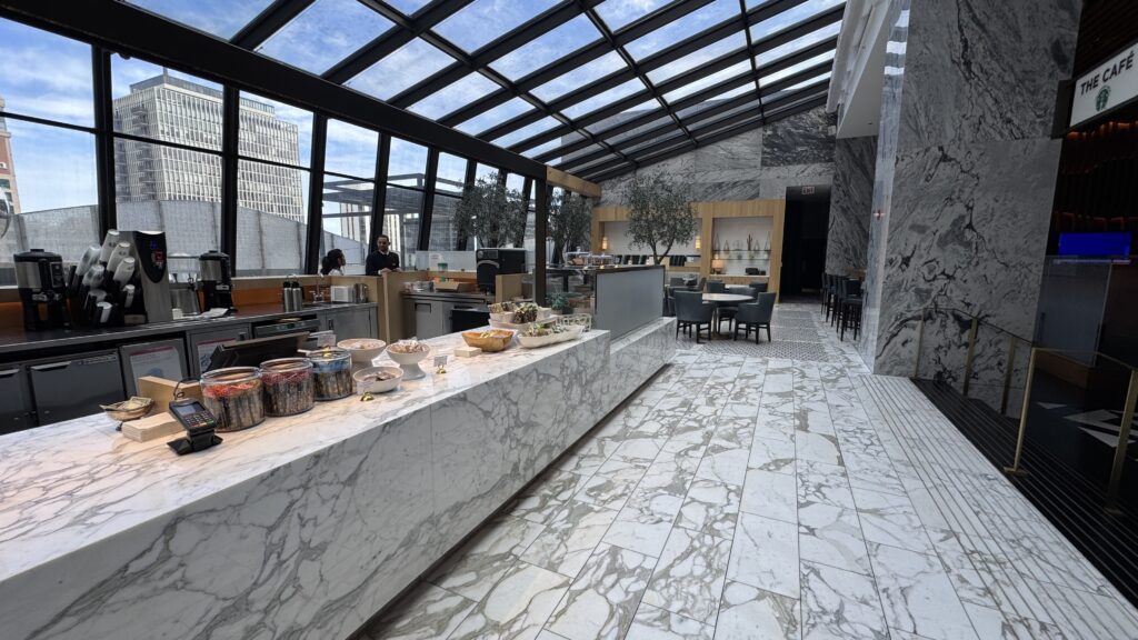 a room with a glass roof and a large counter with food on it