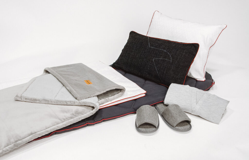 a bed with pillows and slippers