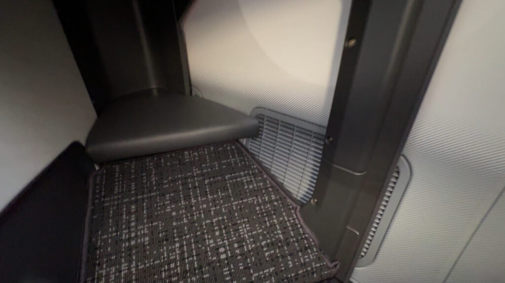 a carpeted seat in a room