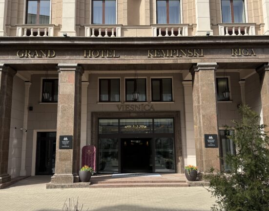 a building with columns and a sign