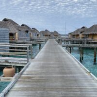 a wooden walkway leading to a beach